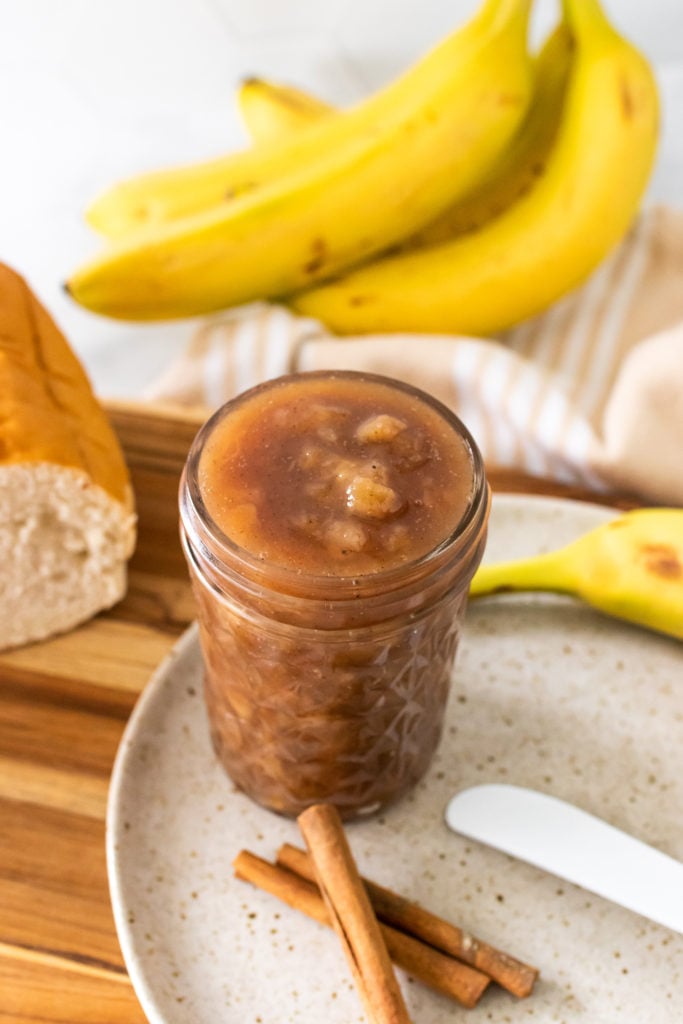 banana rum jam shown in a tall glass jar 
