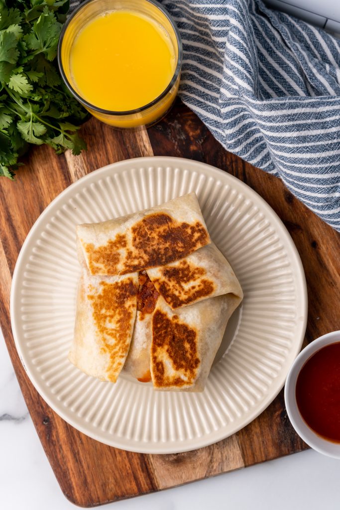 a copycat taco bell breakfast crunch wrap on a white plate
