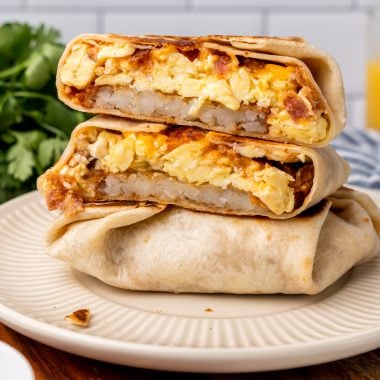 copycat taco bell am breakfast crunch wraps stacked on a white plate