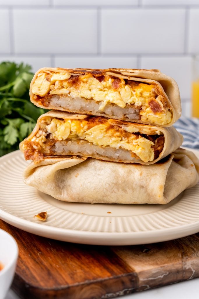 copycat taco bell am breakfast crunch wraps stacked on a white plate