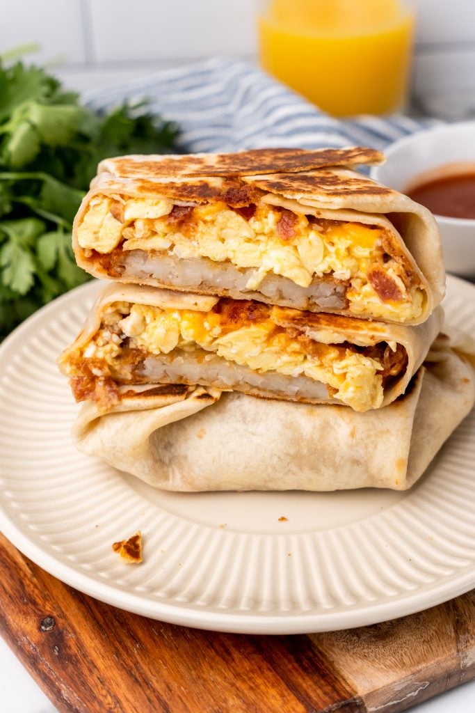 breakfast crunchwraps stacked on a white plate