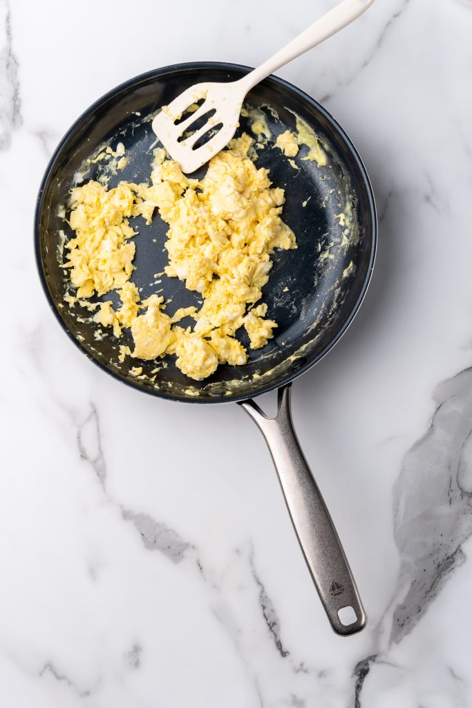 freshly scrambled eggs in a black skillet