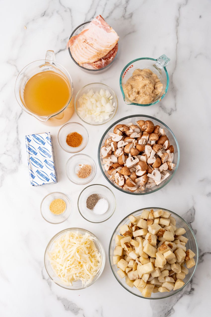 an overhead image showing the measured ingredients needed to make a batch of slow cooker loaded mushroom and potato soup