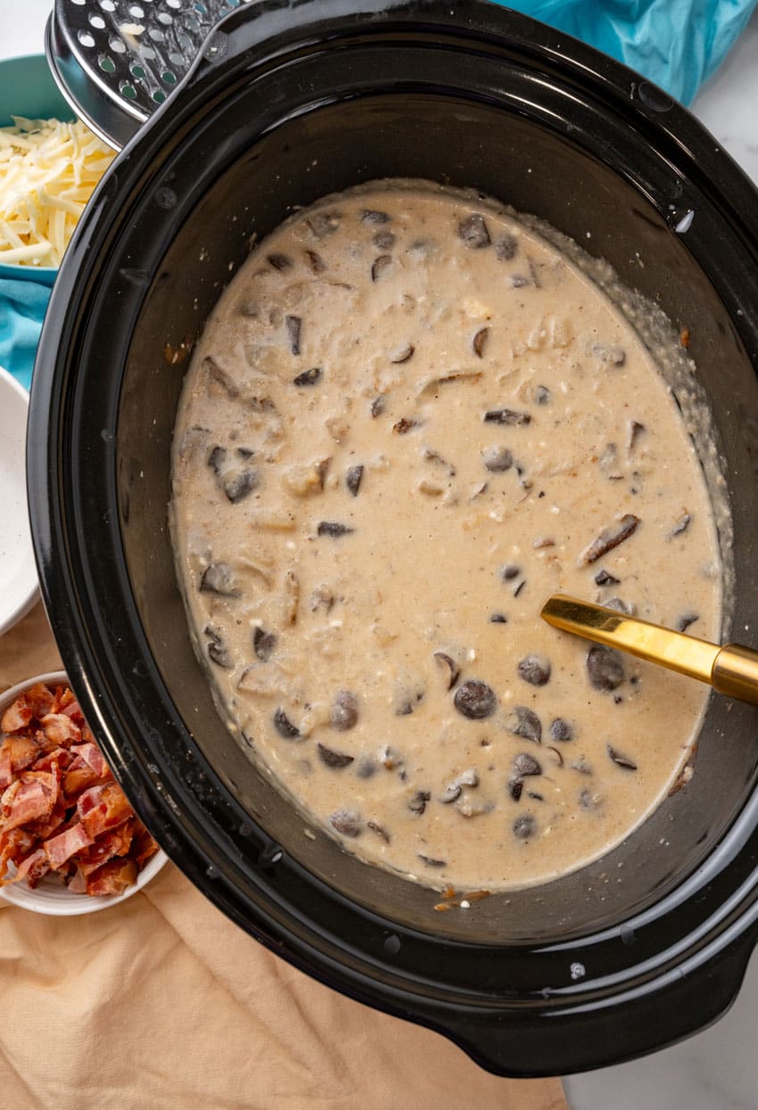 loaded mushroom and potato soup in a black crock pot