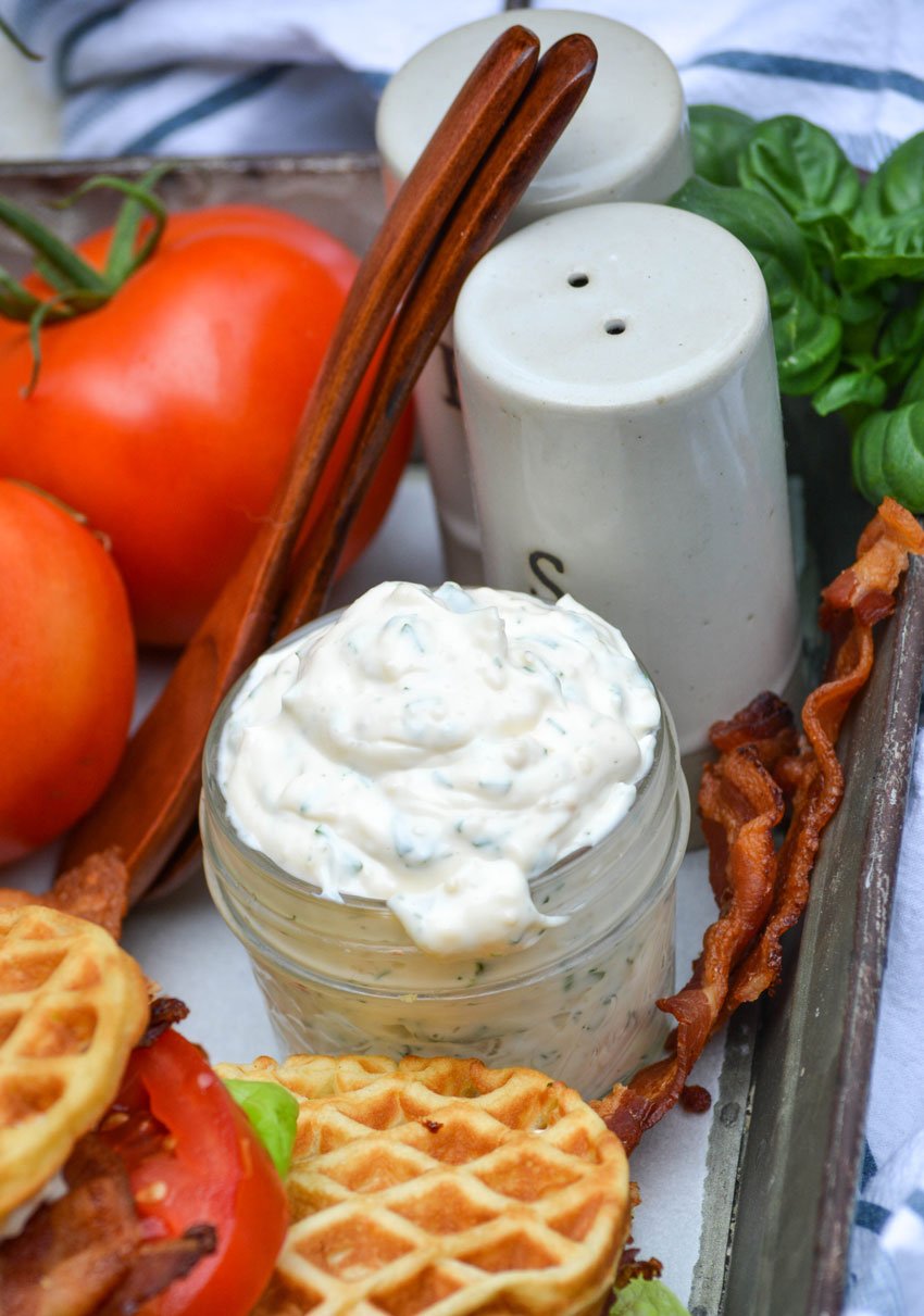 herbed mayo in a glass jar for bacon lettuce tomato waffle-wiches on a metal tray
