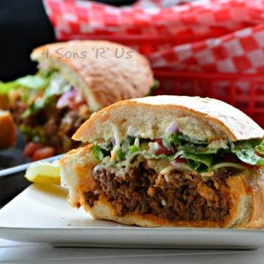 A SLICE OF BACON CHEESEBURGER STUFFED FRENCH BREAD ON A SMALL WHITE PLATE