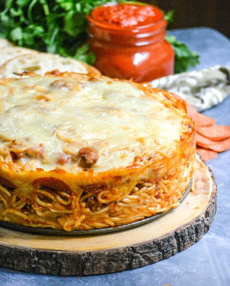 baked spaghetti pie served on a wooden cutting board