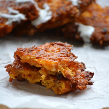 butternut squash fritters on a wrinkled sheet of white parchment paper