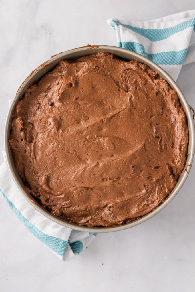 chocolate cheesecake filling in a silver springform pan