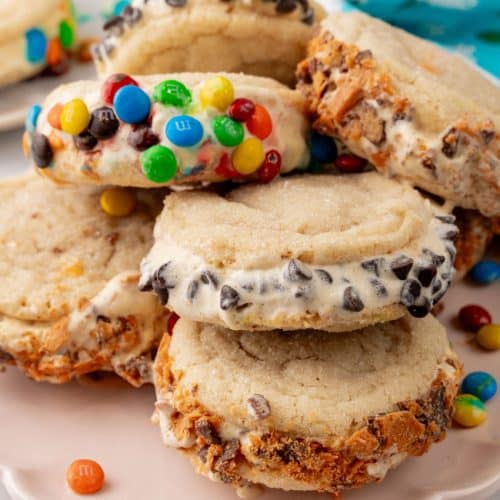 a stack of sugar cookie ice cream sandwiches on a white plate