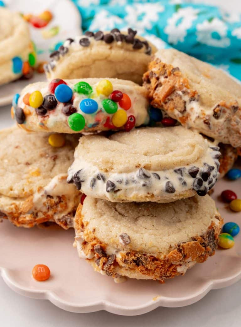 a stack of sugar cookie ice cream sandwiches on a white plate