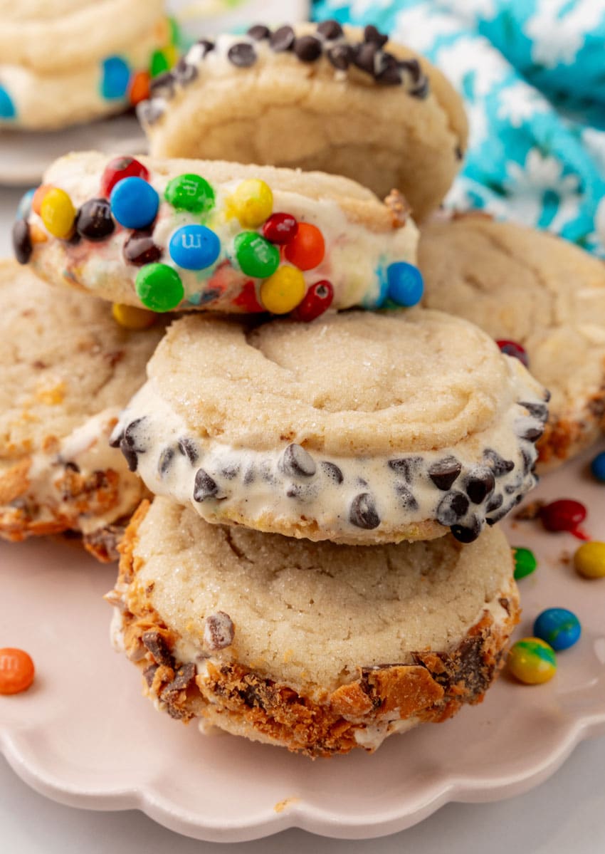 a stack of sugar cookie ice cream sandwiches on a white plate