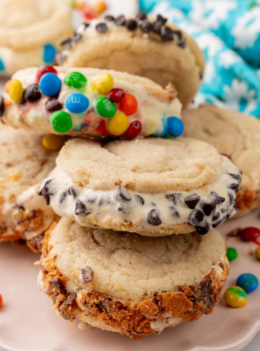 a stack of sugar cookie ice cream sandwiches on a white plate