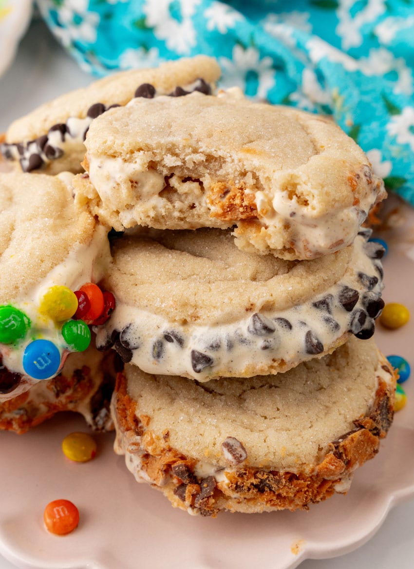 a stack of sugar cookie ice cream sandwiches on a white plate