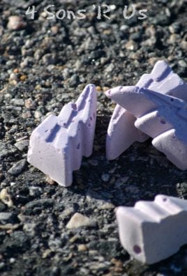 homemade purple sidewalk chalk laying on asphalt