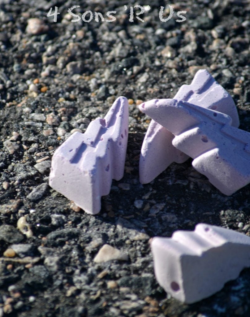 homemade purple sidewalk chalk laying on asphalt