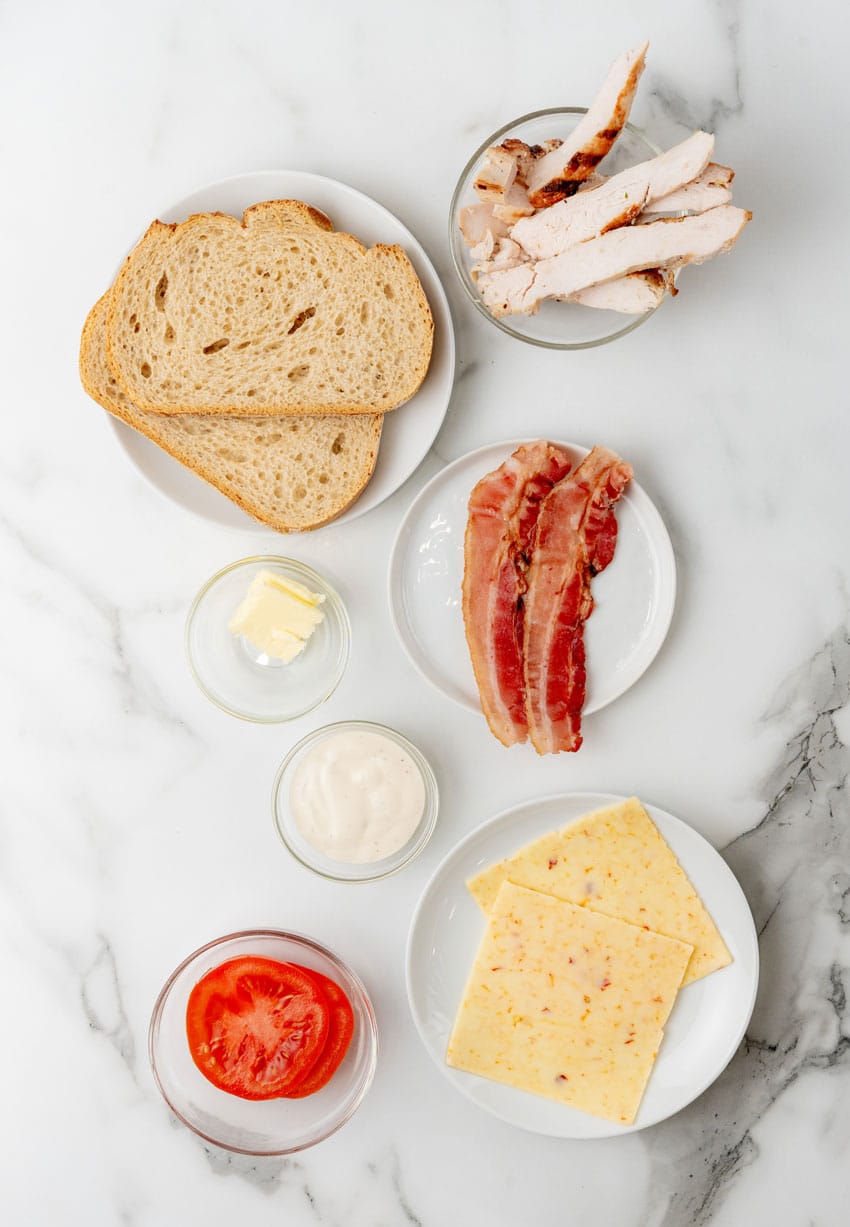 an overhead image showing the measured ingredients needed to make a chipotle chicken bacon ranch panini