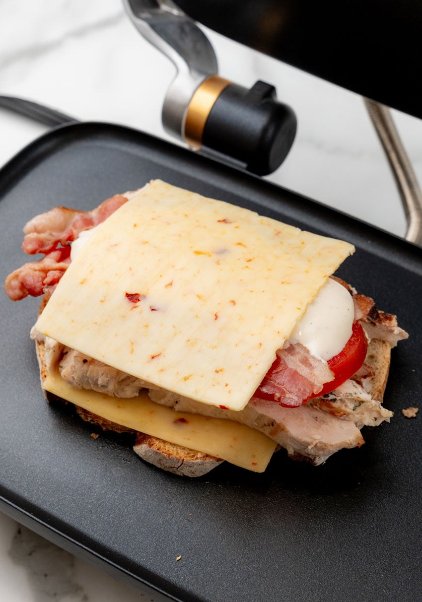 a chipotle chicken bacon ranch sandwich on a panini grill