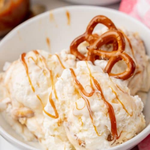 scoops of salted caramel pretzel ice cream in a white bowl