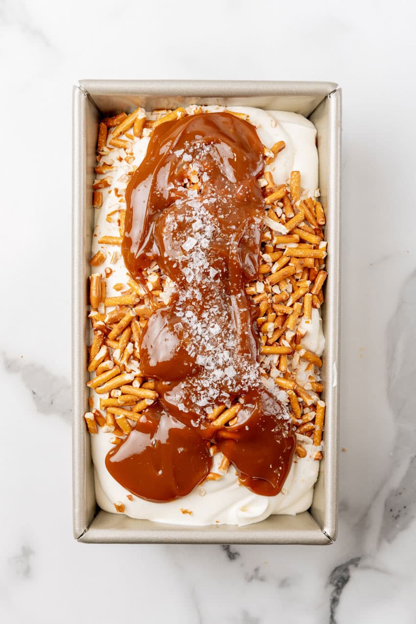 salted caramel pretzel no churn ice cream in a metal loaf pan
