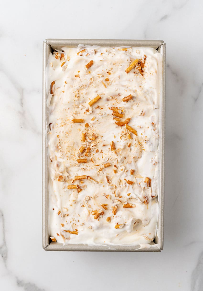 salted caramel pretzel no churn ice cream in a metal loaf pan