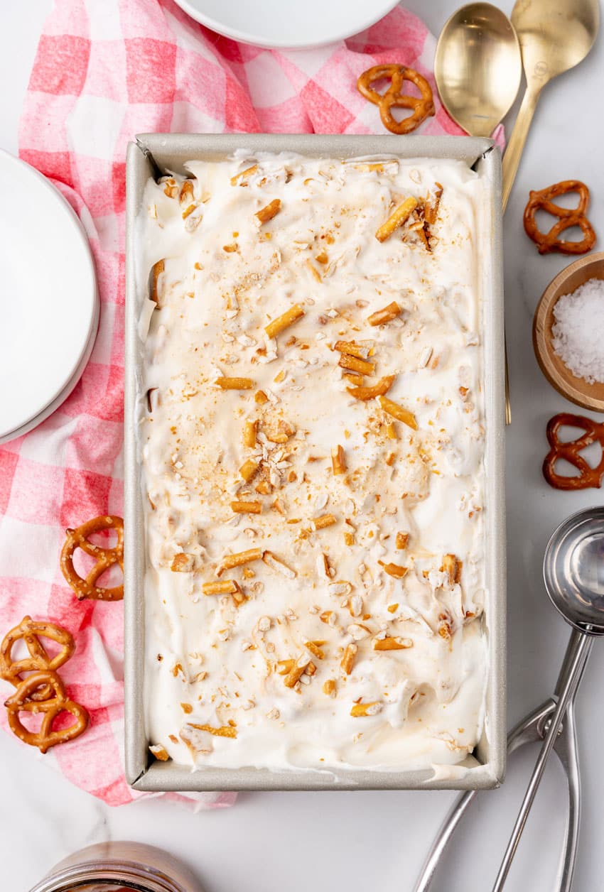 salted caramel pretzel no churn ice cream in a metal loaf pan