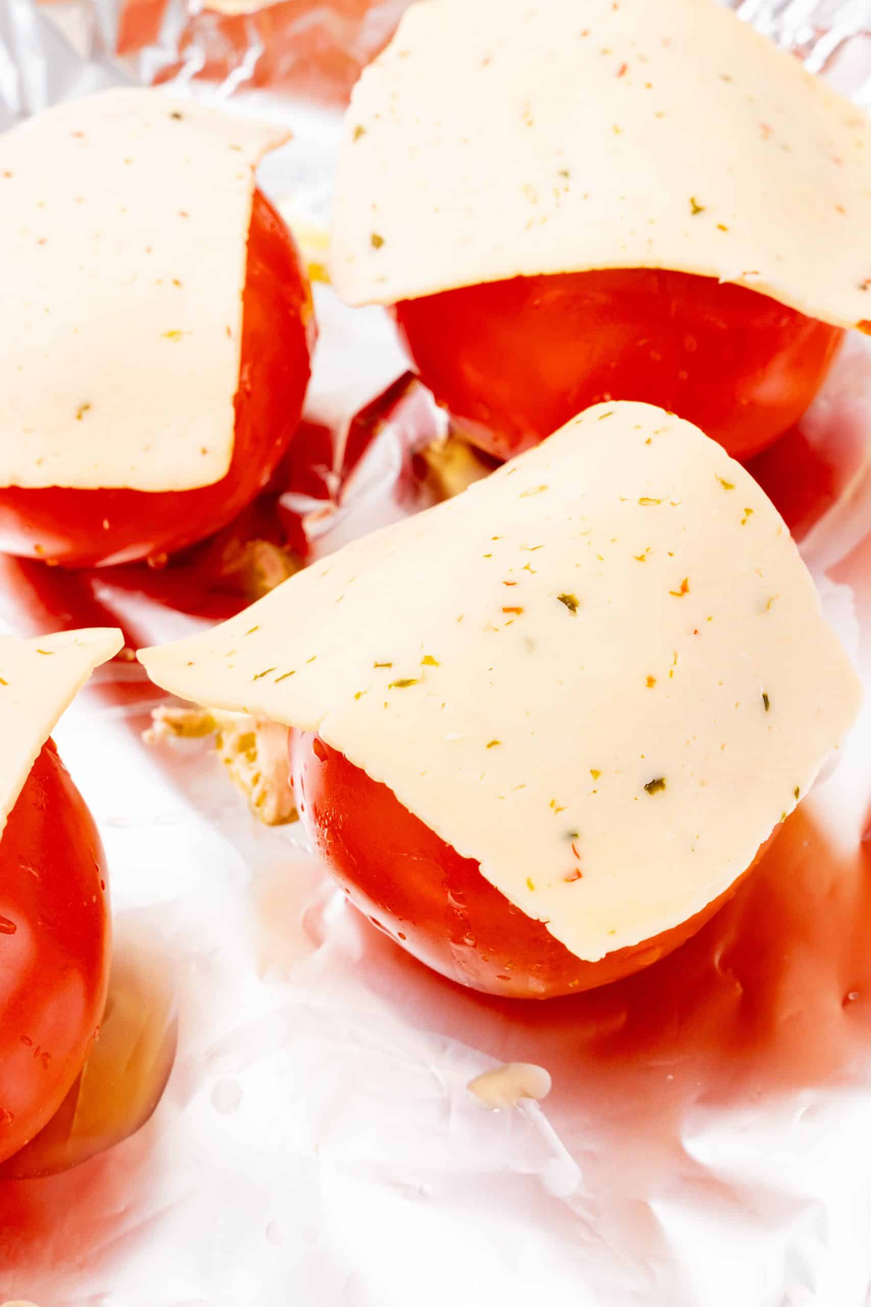 tuna salad stuffed fresh tomatoes topped with a sliced of havarti cheese