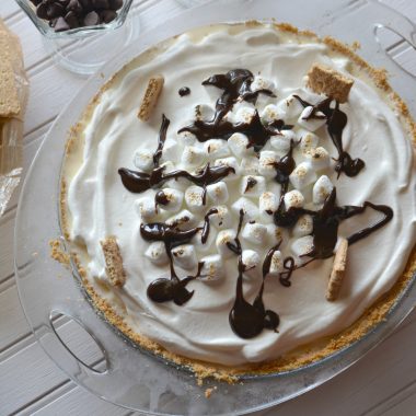 s'mores ice cream pie on a white wooden board