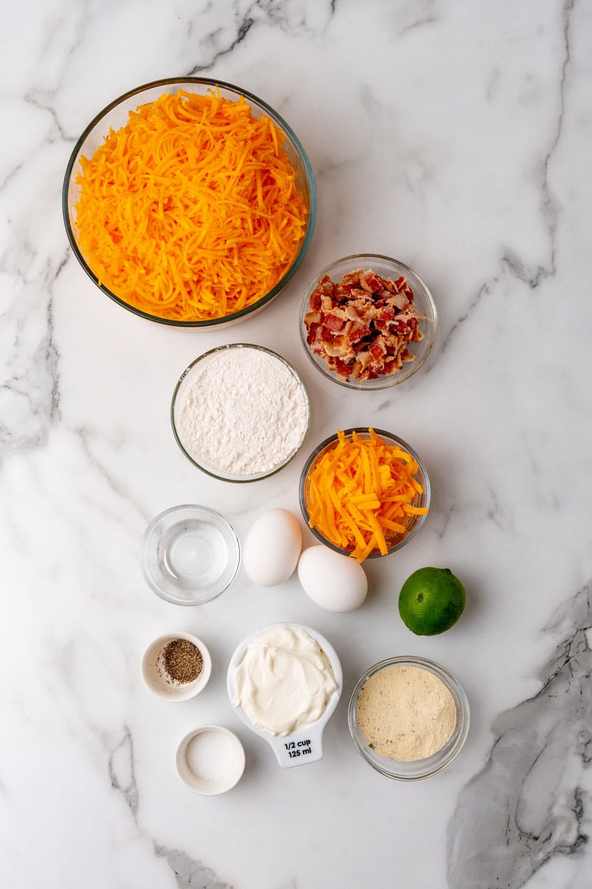 an overhead image showing the measured ingredients needed to make a batch of cheesy bacon butternut squash fritters