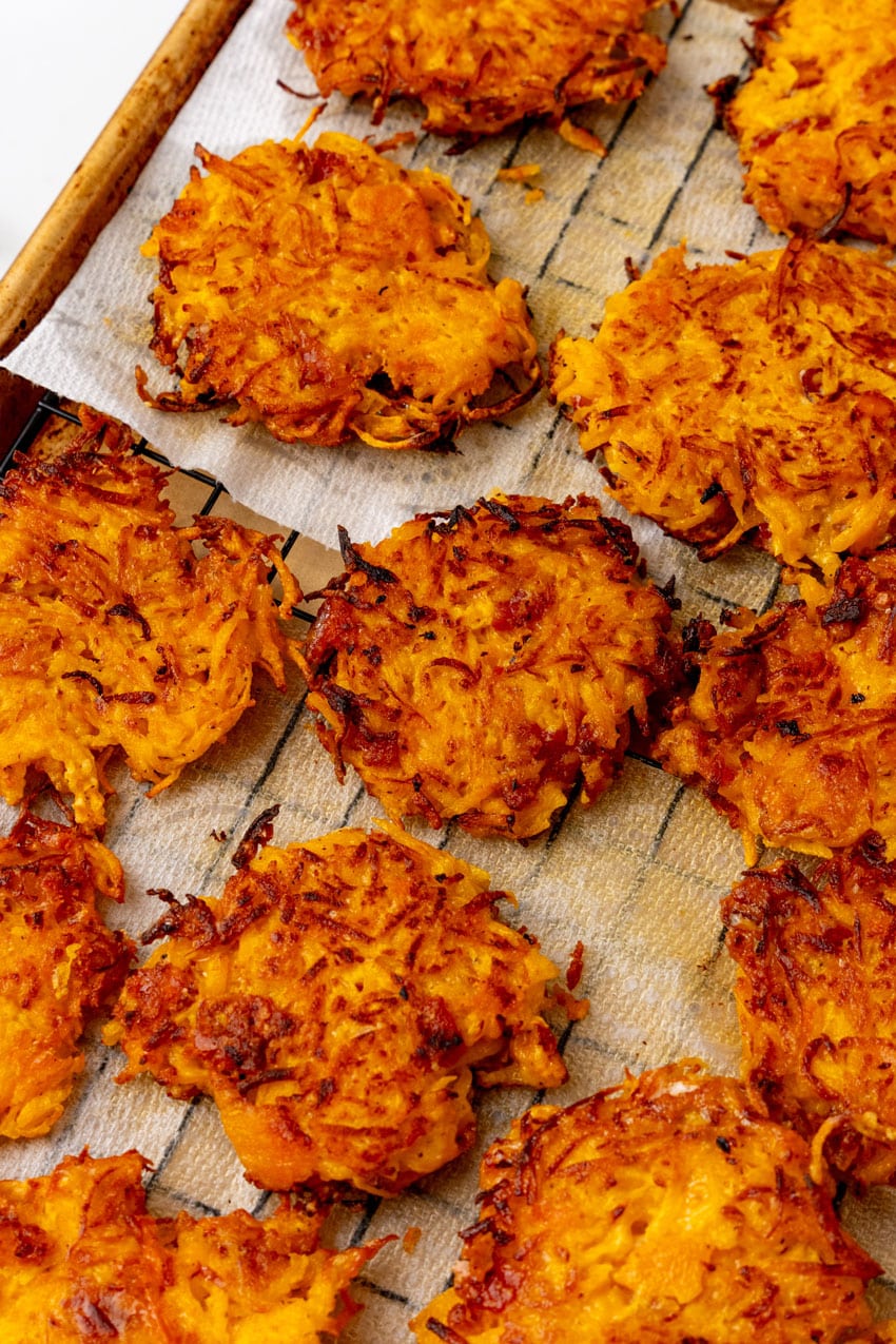 fried butternut squash fritters draining on a wire rack