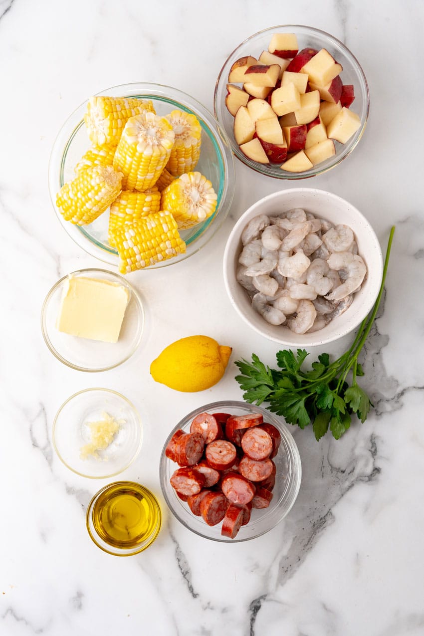 an overhead image showing the measured ingredients needed to make low country boil foil packets