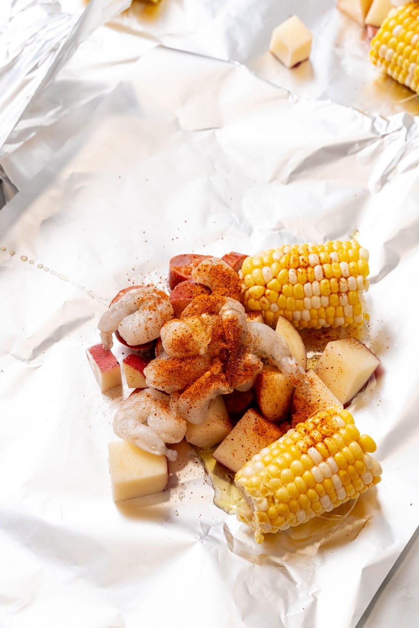 shrimp sausage and cut vegetables on a large sheet of aluminum foil