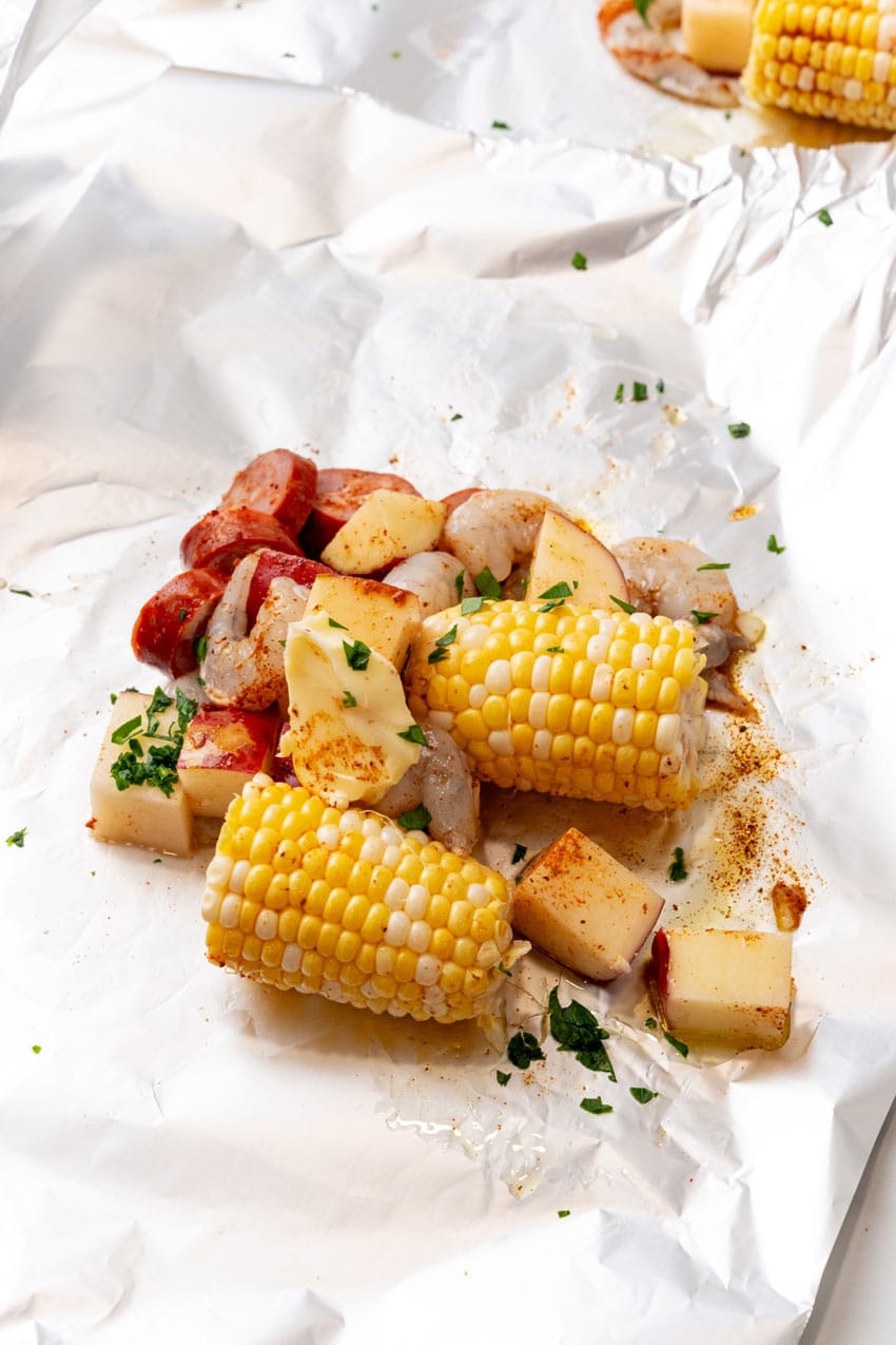 shrimp sausage and cut vegetables on a large sheet of aluminum foil