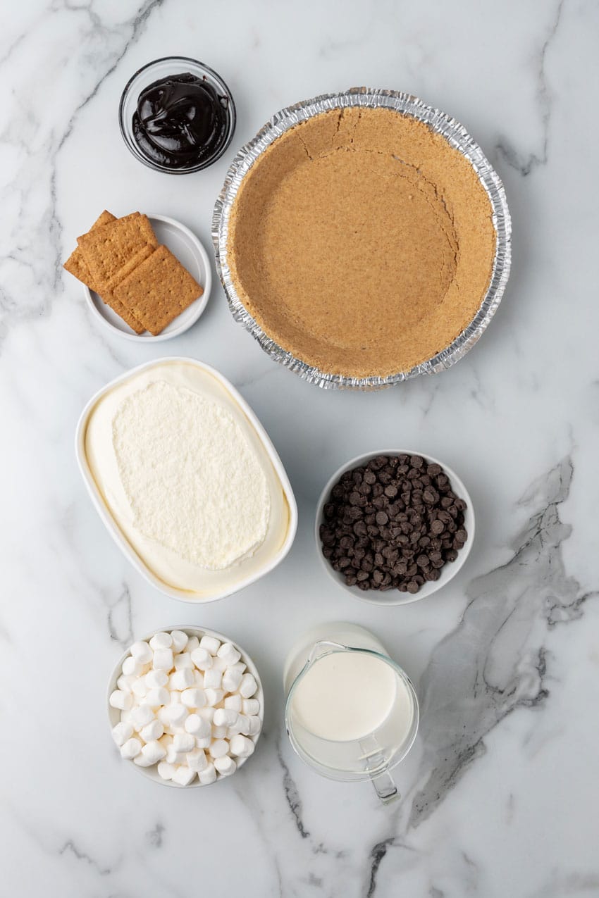 an overhead image showing the measured ingredients needed to make a s'mores ice cream pie