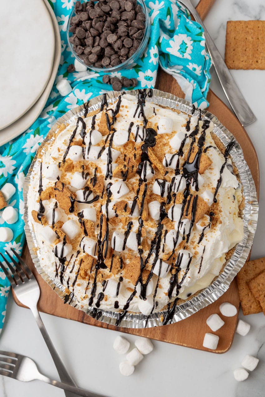 s'mores ice cream pie served on a wooden cutting board 