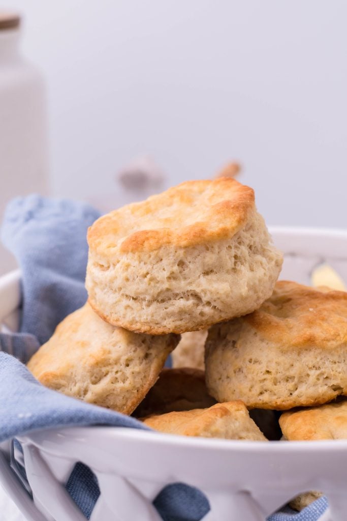 copycat KFC biscuits on a blue cloth in a white ceramic bread bowl