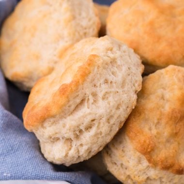 copycat KFC biscuits on a blue cloth in a white ceramic bread bowl