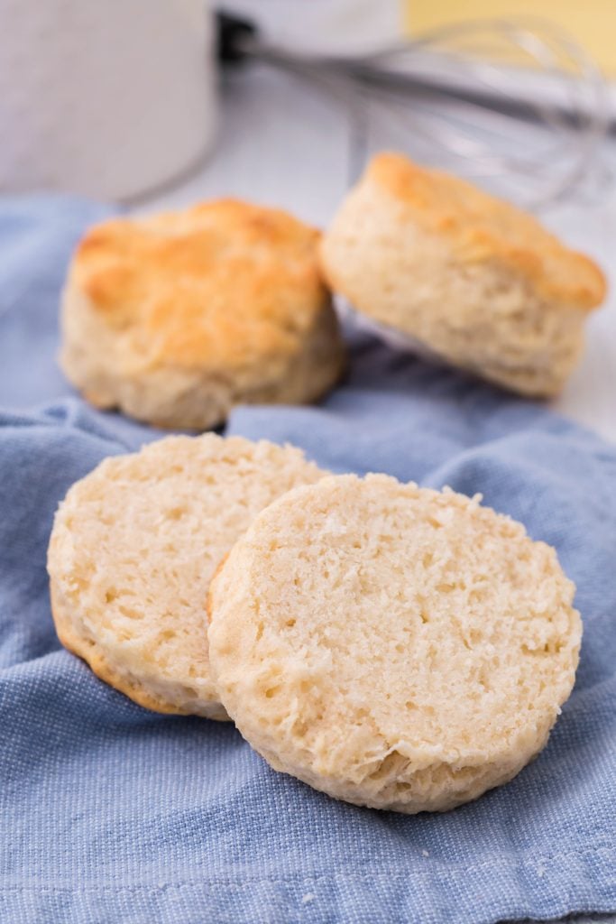 a copycat kfc biscuit sliced in half on a blue cloth