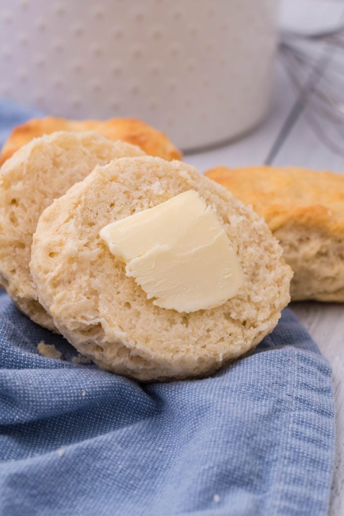 a copycat kfc biscuit sliced in half on a blue cloth