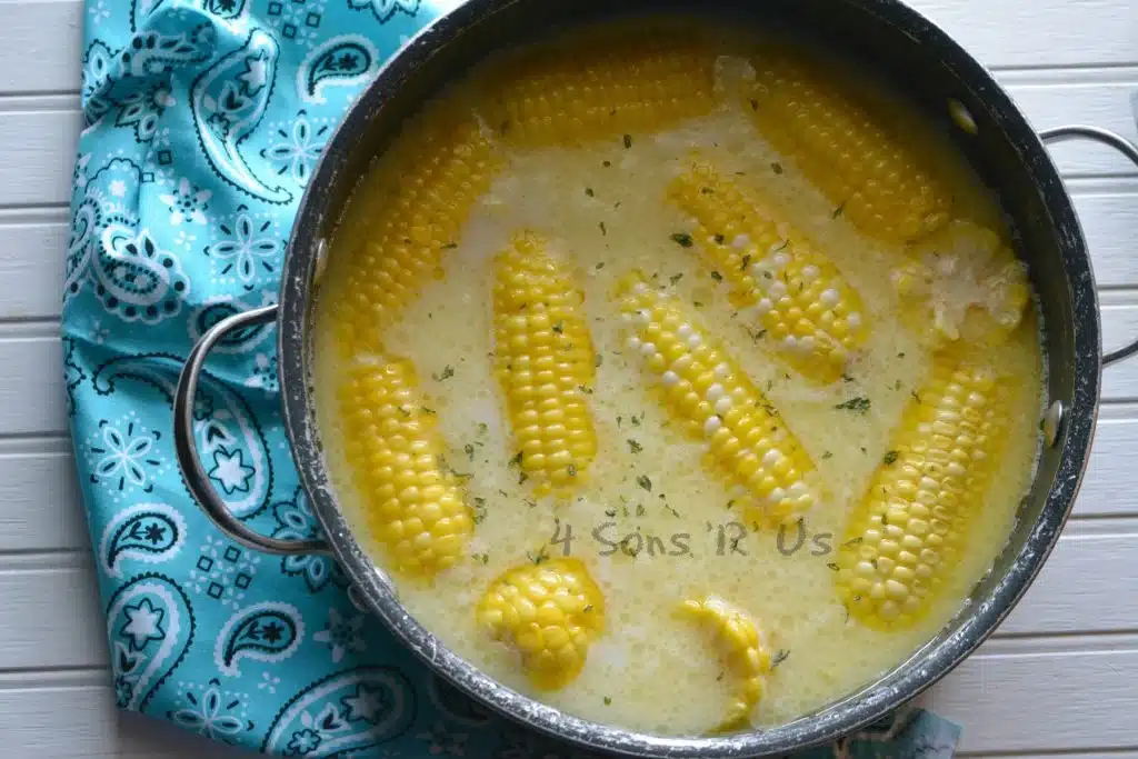 down home milk and honey corn on the cob in a large pot filled with seasoned milk