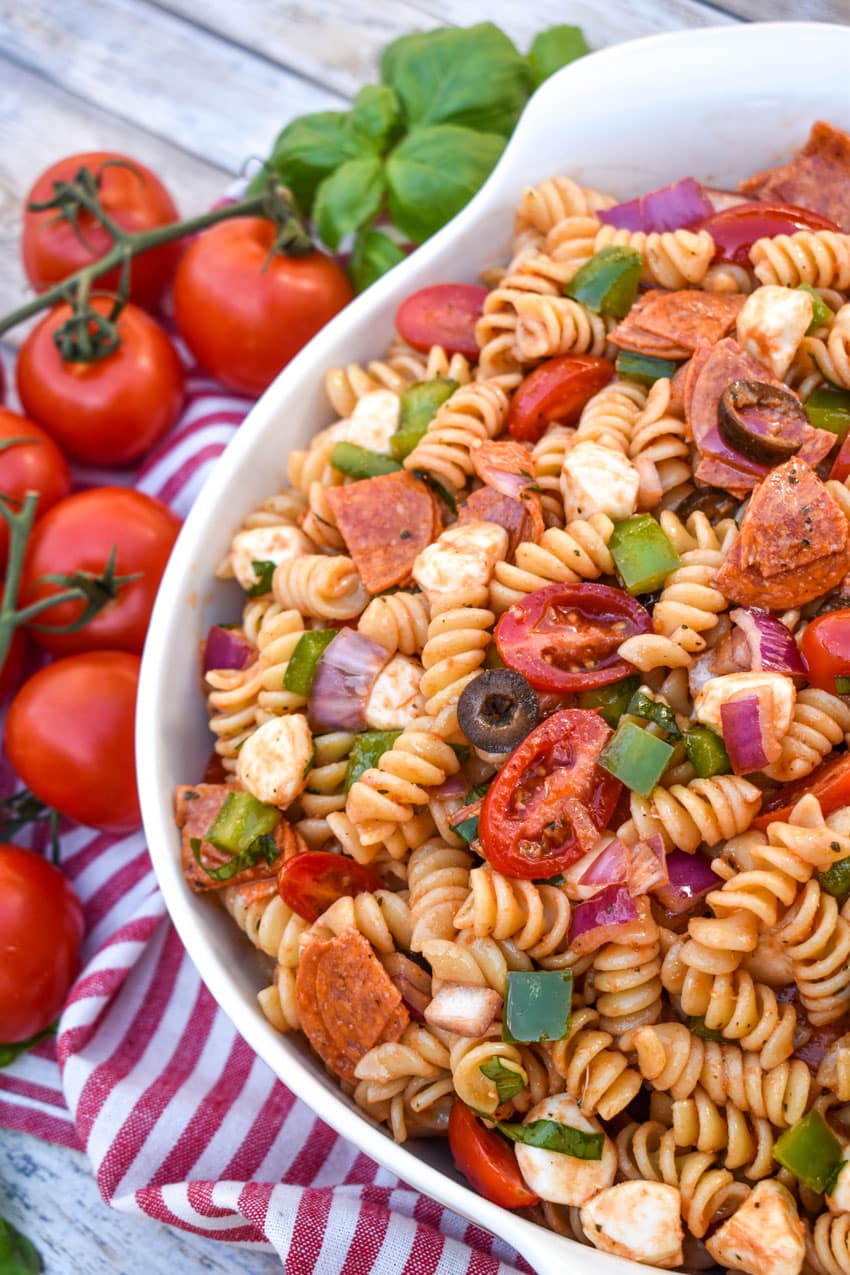 pizza pasta salad in a large white serving bowl