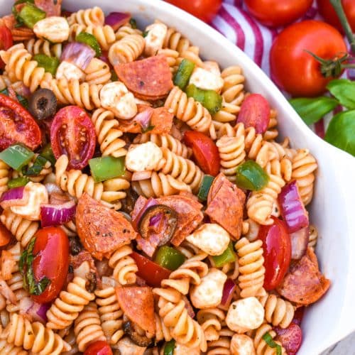 pizza pasta salad in a large white serving bowl