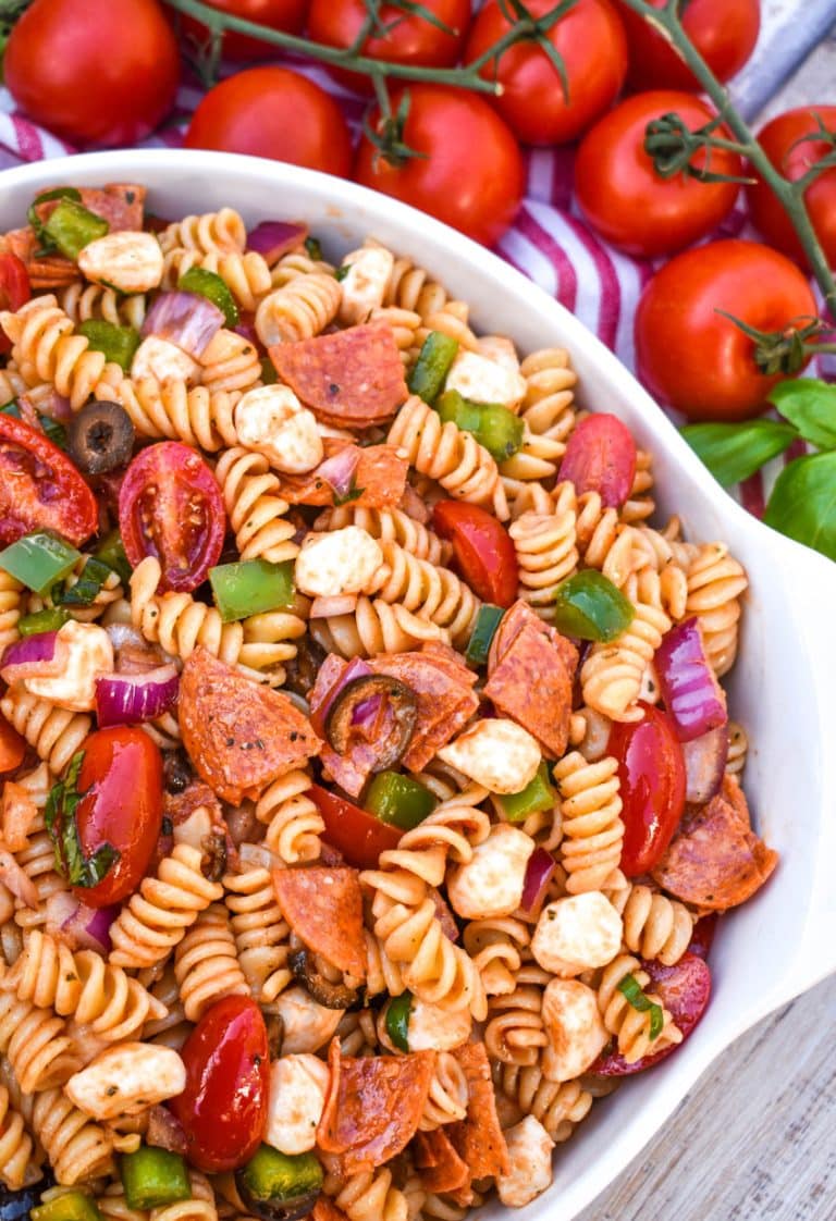 pizza pasta salad in a large white serving bowl