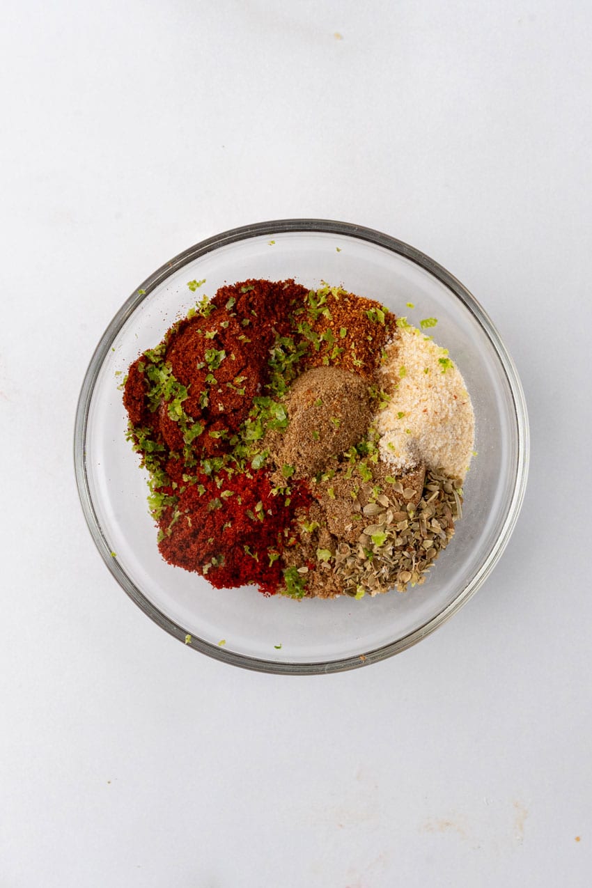 different spices in a single glass mixing bowl