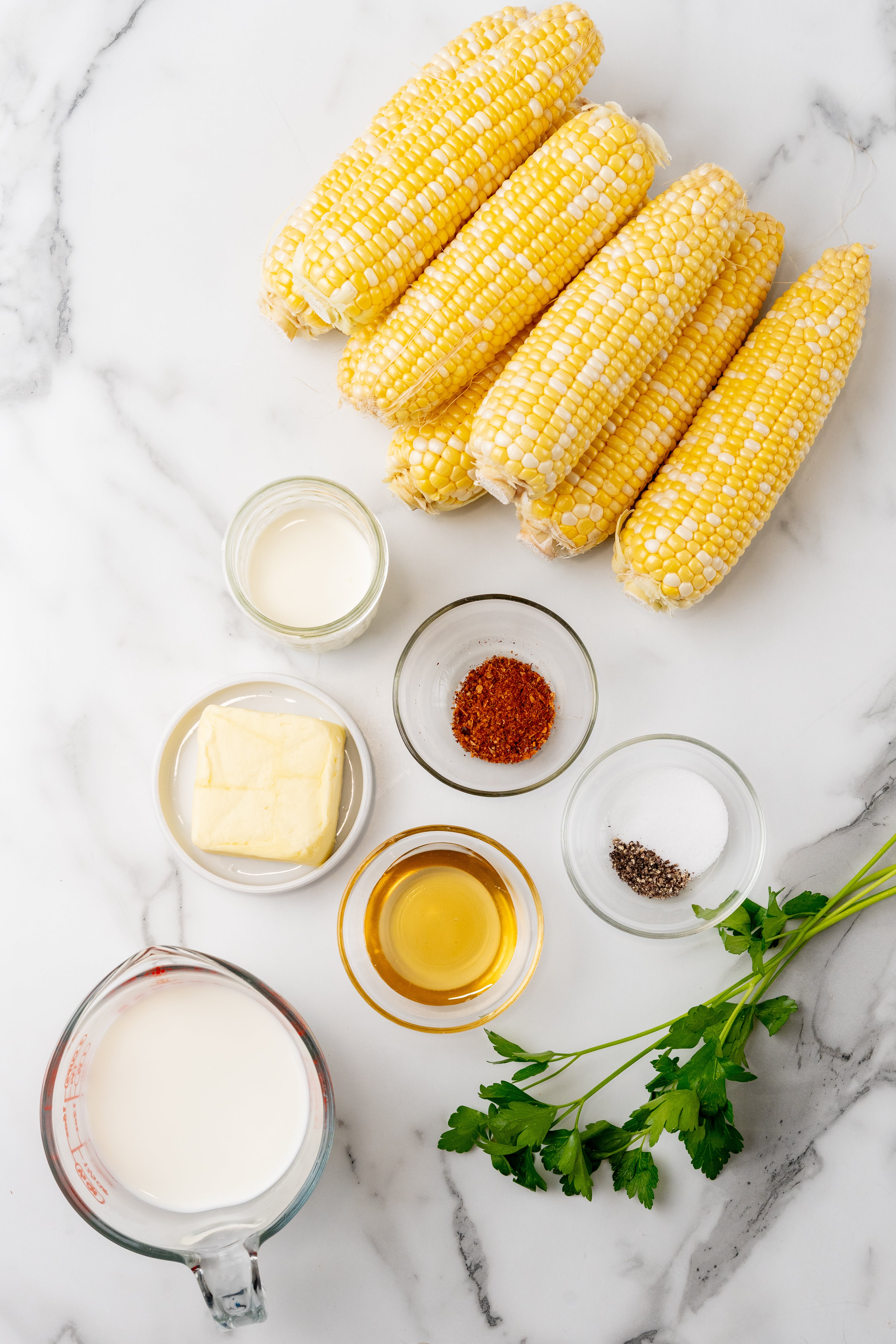 an overhead image showing the measured ingredients needed to make a batch of southern milk and honey corn on the cob
