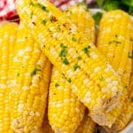 milk and honey corn on the cob piled on a white serving platter