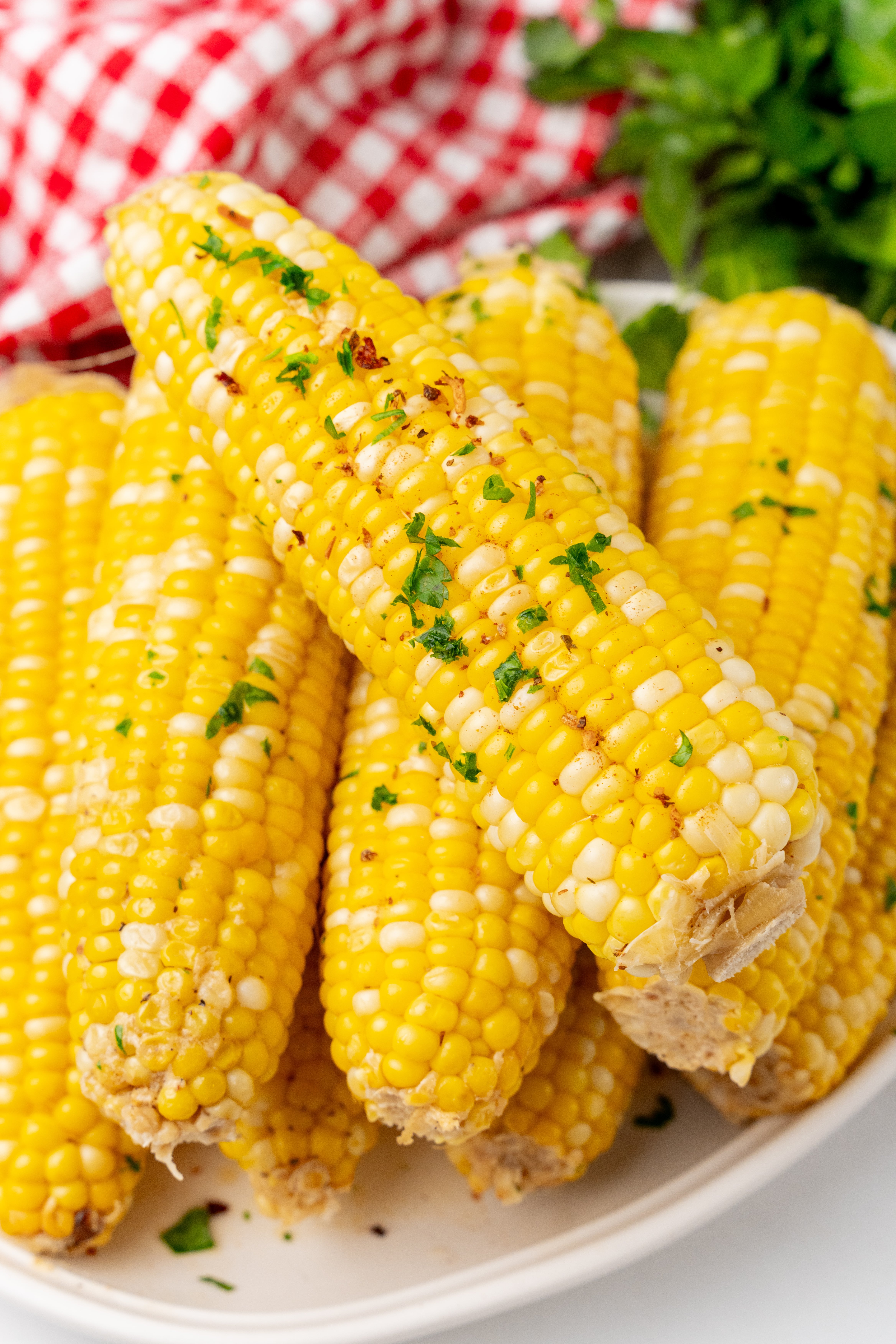 milk and honey corn on the cob piled on a white serving platter