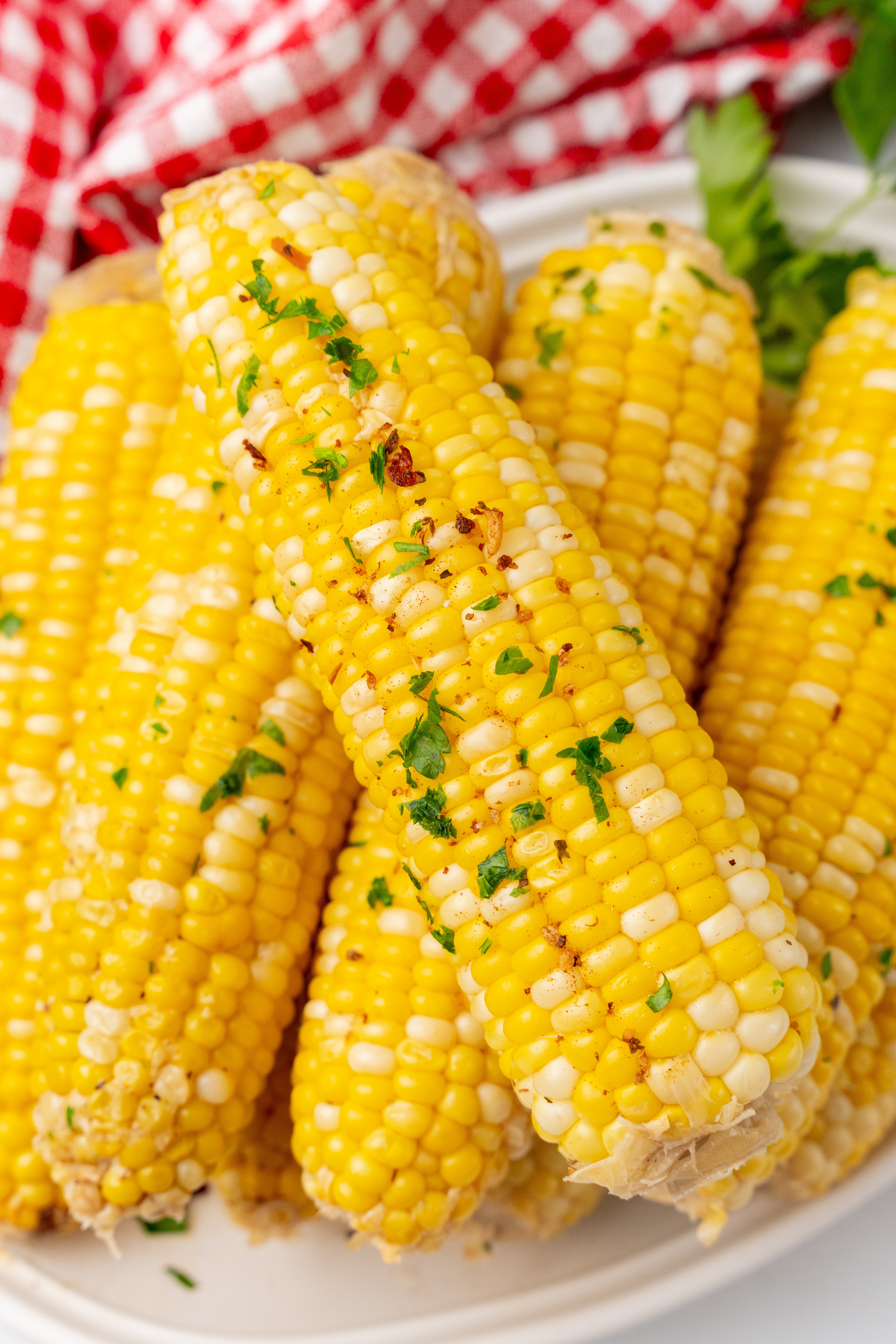 milk and honey corn on the cob piled on a white serving platter