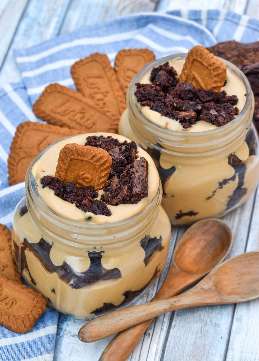 two brownie trifles with cookie butter in small mason jars