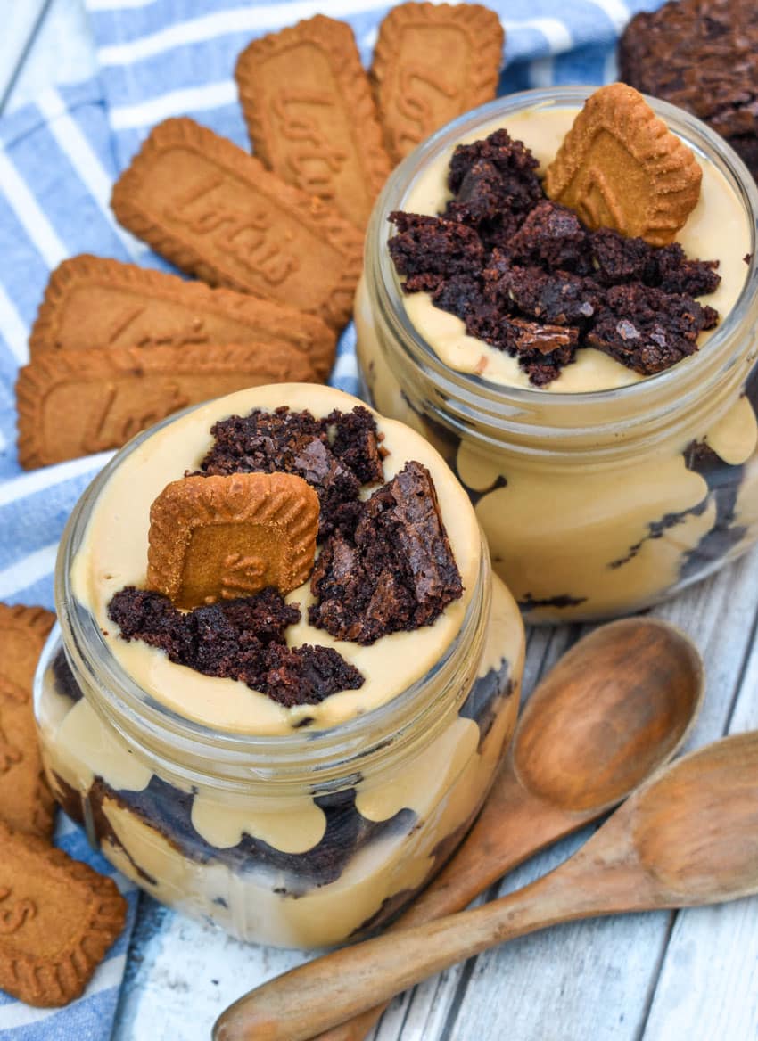 two brownie trifles with cookie butter in small mason jars
